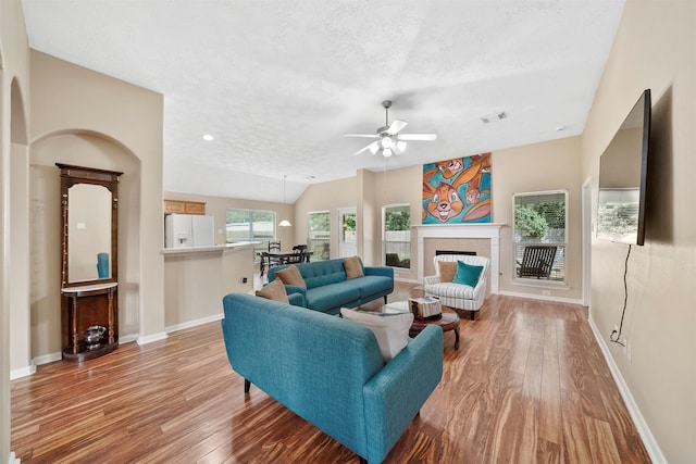 1497 Allison St, Alvin, TX 77511 - living room featuring wood finished floors, ceiling fan, baseboards, a textured ceiling, and vaulted ceiling