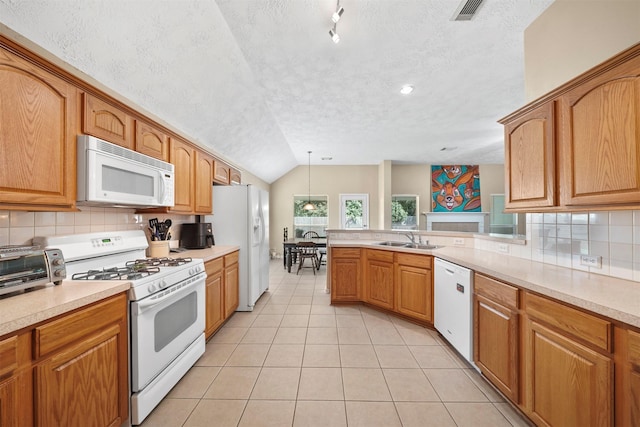 1497 Allison St, Alvin, TX 77511 - kitchen featuring white appliances, a textured ceiling, a sink, light tile patterned floors, and lofted ceiling