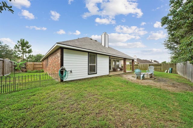 1497 Allison St, Alvin, TX 77511 - rear view of property with brick siding, a patio, and a chimney