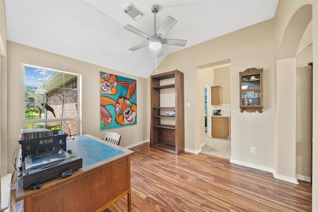 1497 Allison St, Alvin, TX 77511 - office area featuring light wood-style floors, a ceiling fan, baseboards, lofted ceiling, and arched walkways
