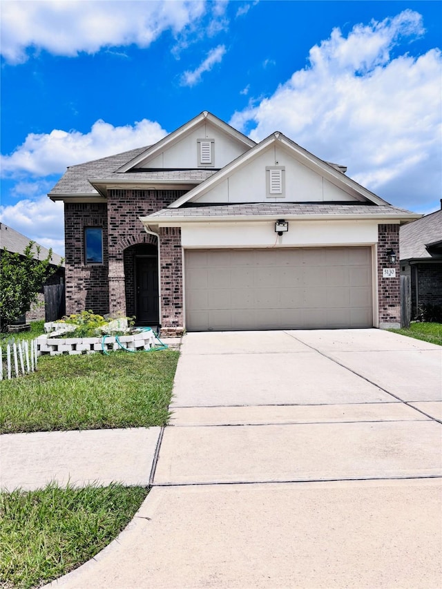 5130 Klein Orchard Dr, Houston, TX 77066 - view of front of home featuring driveway, a garage, brick siding, and roof with shingles