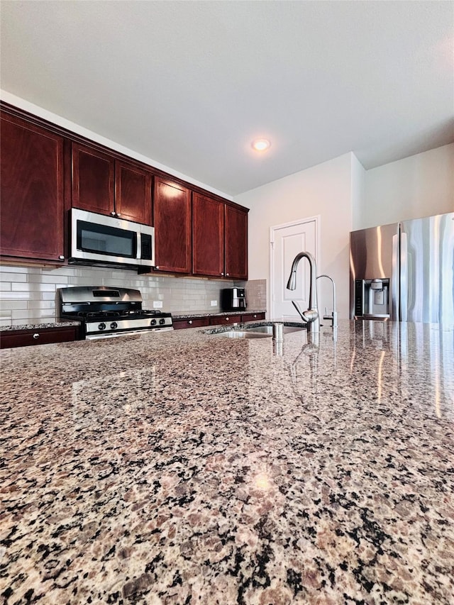 5130 Klein Orchard Dr, Houston, TX 77066 - kitchen with appliances with stainless steel finishes, light stone counters, tasteful backsplash, a sink, and recessed lighting