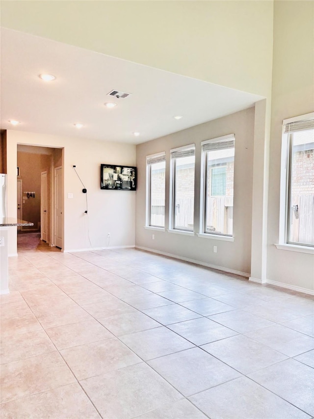 5130 Klein Orchard Dr, Houston, TX 77066 - empty room with light tile patterned floors, plenty of natural light, baseboards, and recessed lighting