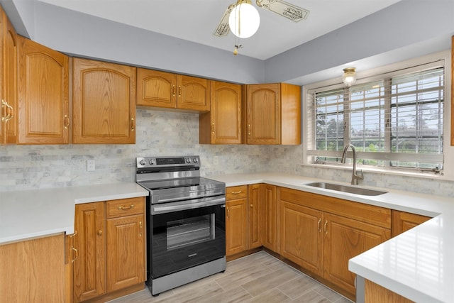 3919 Gardendale Dr, Houston, TX 77092 - kitchen with stainless steel electric range, a sink, backsplash, and light countertops
