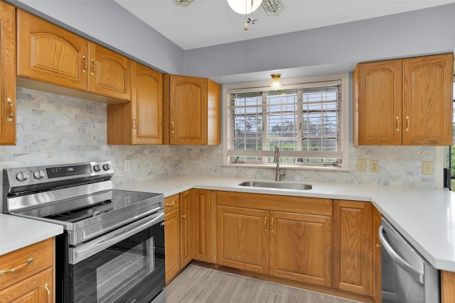 3919 Gardendale Dr, Houston, TX 77092 - kitchen with appliances with stainless steel finishes, a sink, light countertops, and decorative backsplash