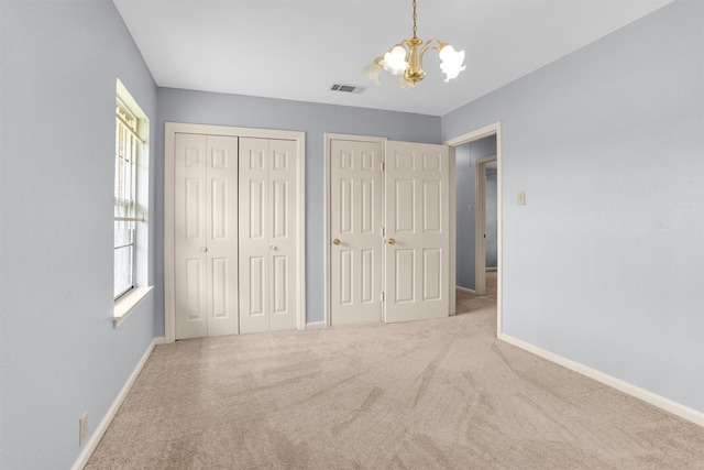 3919 Gardendale Dr, Houston, TX 77092 - unfurnished bedroom featuring a chandelier, carpet flooring, baseboards, and multiple closets