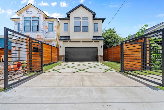 6613 Ave O, Houston, TX 77011 - view of front facade with stucco siding, a standing seam roof, concrete driveway, and stone siding