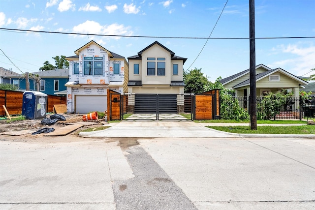 6613 Ave O, Houston, TX 77011 - view of front of property featuring driveway, a gate, an attached garage, a standing seam roof, and a metal roof
