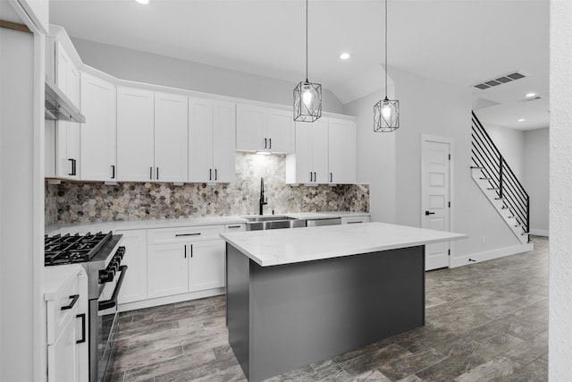 6613 Ave O, Houston, TX 77011 - kitchen featuring appliances with stainless steel finishes, backsplash, white cabinetry, recessed lighting, and pendant lighting