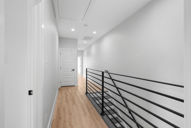 6613 Ave O, Houston, TX 77011 - hall featuring an upstairs landing, attic access, light wood-style floors, and recessed lighting