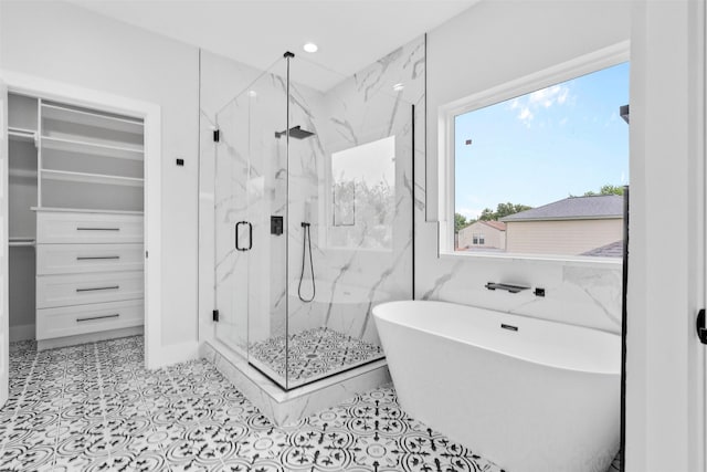 6613 Ave O, Houston, TX 77011 - bathroom with a marble finish shower, a soaking tub, recessed lighting, and a spacious closet