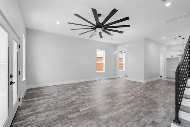 6613 Ave O, Houston, TX 77011 - unfurnished living room featuring recessed lighting, wood finished floors, a ceiling fan, and a chandelier