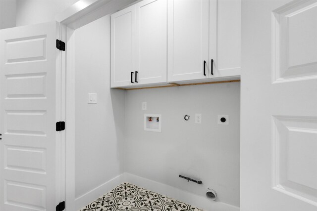 6613 Ave O, Houston, TX 77011 - washroom with hookup for a gas dryer, cabinet space, hookup for a washing machine, tile patterned flooring, and hookup for an electric dryer