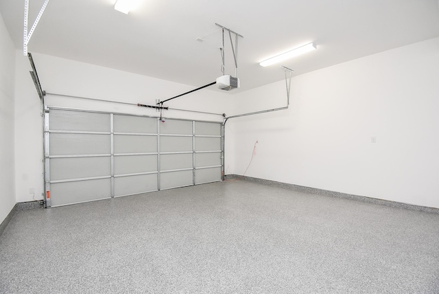 6613 Ave O, Houston, TX 77011 - garage with a garage door opener and baseboards