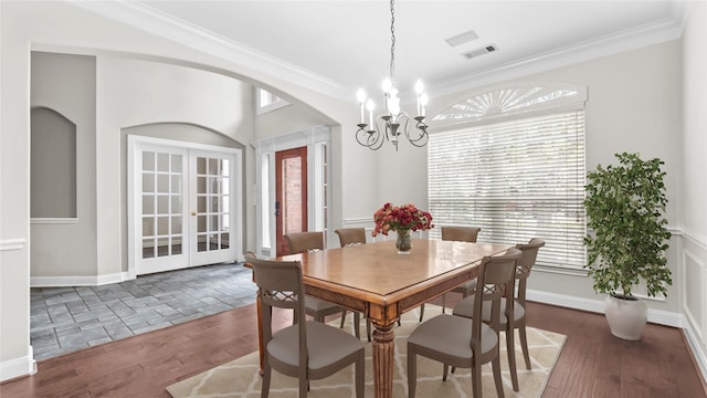 9710 Sotherloch Lake Dr, Spring, TX 77379 - dining room with wood finished floors, a chandelier, ornamental molding, french doors, and arched walkways