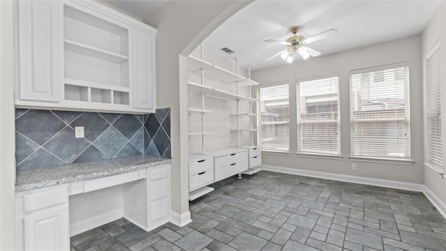 9710 Sotherloch Lake Dr, Spring, TX 77379 - kitchen with open shelves, tasteful backsplash, a ceiling fan, and baseboards
