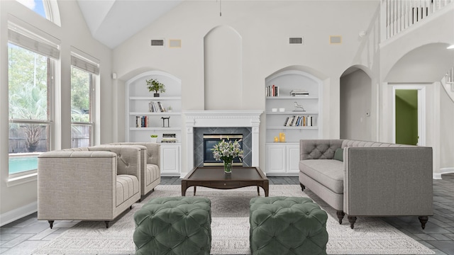 9710 Sotherloch Lake Dr, Spring, TX 77379 - living room featuring built in features, high vaulted ceiling, plenty of natural light, baseboards, and a fireplace