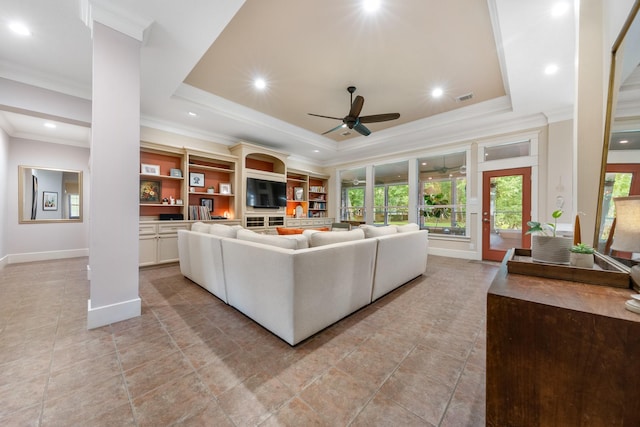 11710 Creek View Ln, Conroe, TX 77385 - living room featuring a raised ceiling, light tile patterned floors, a ceiling fan, ornamental molding, and baseboards
