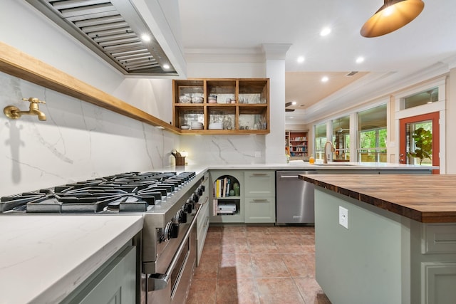 11710 Creek View Ln, Conroe, TX 77385 - kitchen featuring stainless steel appliances, butcher block counters, open shelves, wall chimney exhaust hood, and crown molding