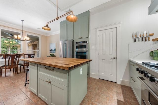 11710 Creek View Ln, Conroe, TX 77385 - kitchen with wooden counters, stainless steel appliances, a chandelier, a kitchen island, and pendant lighting