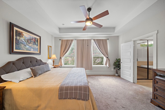 2027 Tarfite Pl, Houston, TX 77077 - carpeted bedroom with a tray ceiling, baseboards, and a ceiling fan