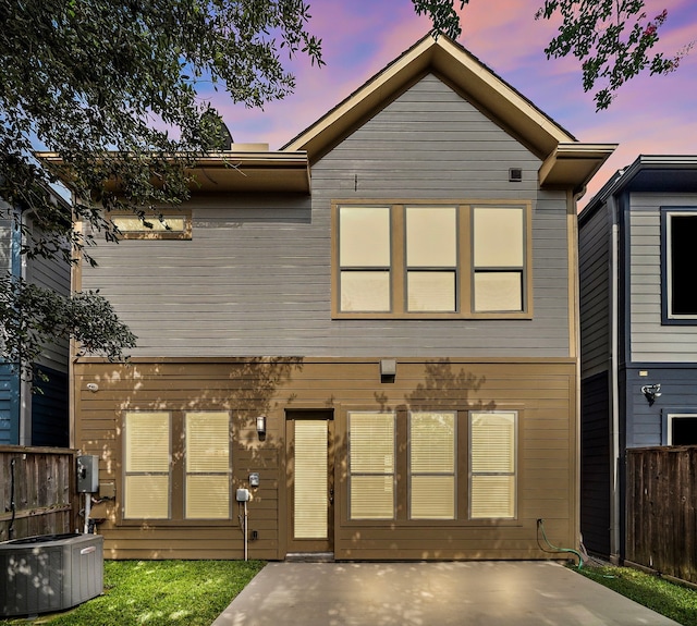 2027 Tarfite Pl, Houston, TX 77077 - back of house at dusk featuring cooling unit and a patio