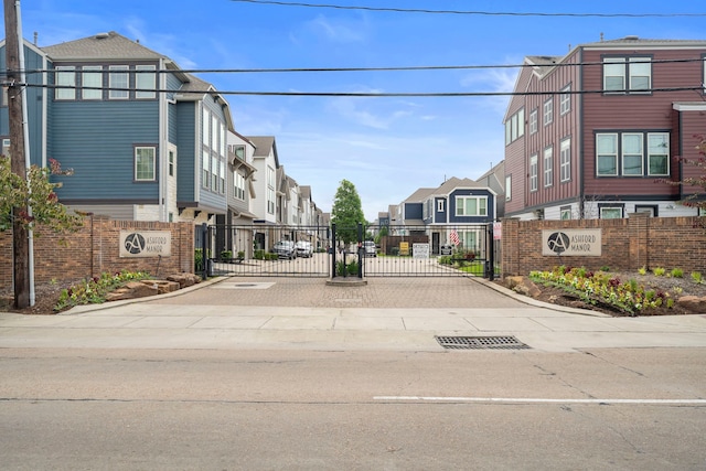 2027 Tarfite Pl, Houston, TX 77077 - view of street with a residential view, a gate, a gated entry, and curbs