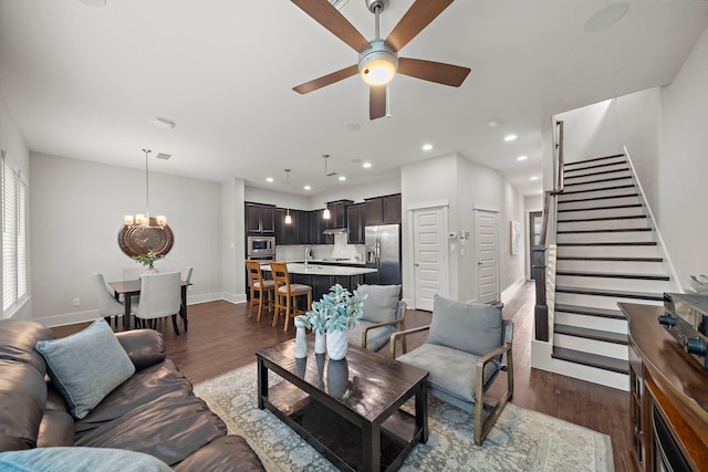2027 Tarfite Pl, Houston, TX 77077 - living room featuring a ceiling fan, stairs, baseboards, dark wood-style flooring, and recessed lighting