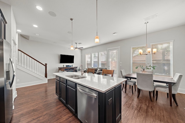 2027 Tarfite Pl, Houston, TX 77077 - kitchen with stainless steel appliances, a sink, dark wood-style flooring, a chandelier, and dark cabinetry
