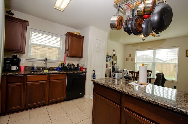 9414 Emerald Green Dr, Rosharon, TX 77583 - kitchen with black dishwasher, a sink, light tile patterned floors, and dark stone counters