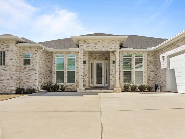 236 Bentwood Dr, Montgomery, TX 77356 - entrance to property featuring a shingled roof, brick siding, and concrete driveway