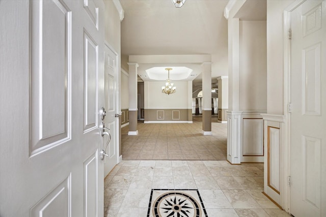 10115 Willow Crossing Dr, Houston, TX 77064 - entryway featuring a chandelier, decorative columns, light tile patterned floors, and a decorative wall