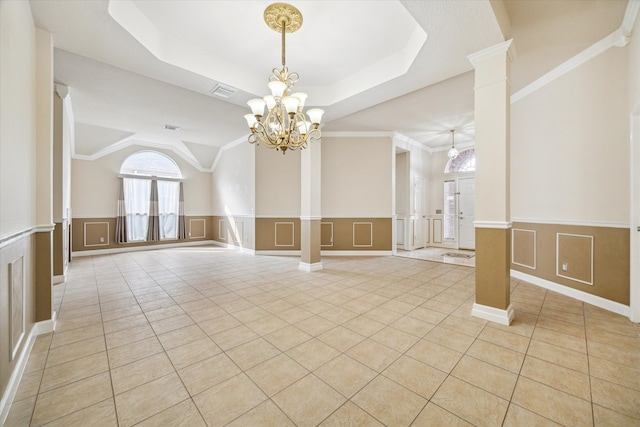 10115 Willow Crossing Dr, Houston, TX 77064 - unfurnished room featuring a chandelier, light tile patterned floors, a decorative wall, wainscoting, and a raised ceiling
