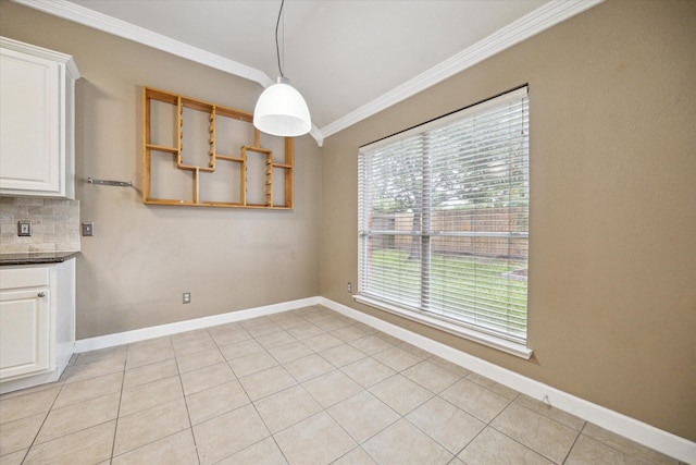 10115 Willow Crossing Dr, Houston, TX 77064 - unfurnished dining area featuring ornamental molding, baseboards, and light tile patterned flooring