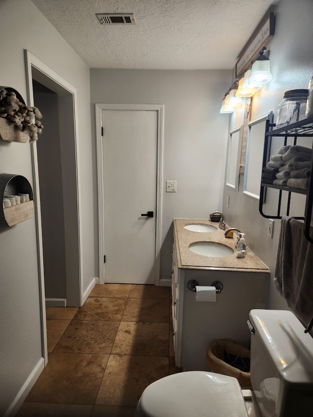 27491 Lantern Ln, New Caney, TX 77357 - bathroom with double vanity and a textured ceiling