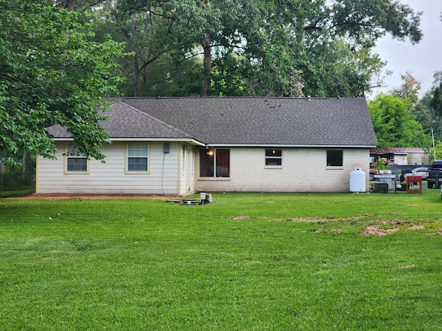 27491 Lantern Ln, New Caney, TX 77357 - back of property with roof with shingles and a lawn