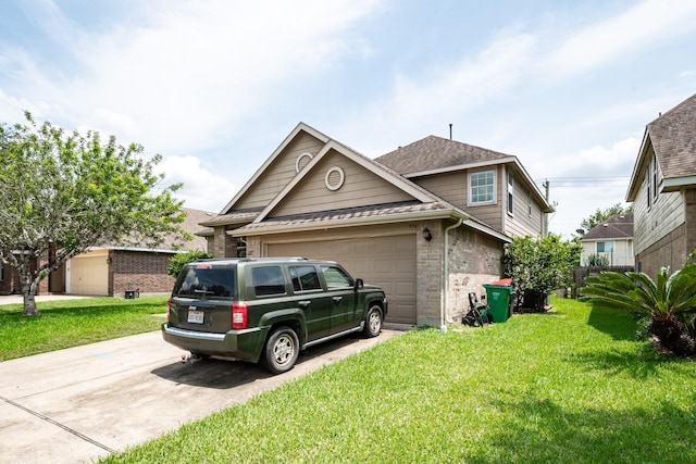 934 Sage St, Baytown, TX 77521 - view of front facade featuring brick siding, driveway, a front yard, and an attached garage