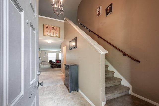 934 Sage St, Baytown, TX 77521 - entryway featuring light carpet, stairway, baseboards, and a chandelier