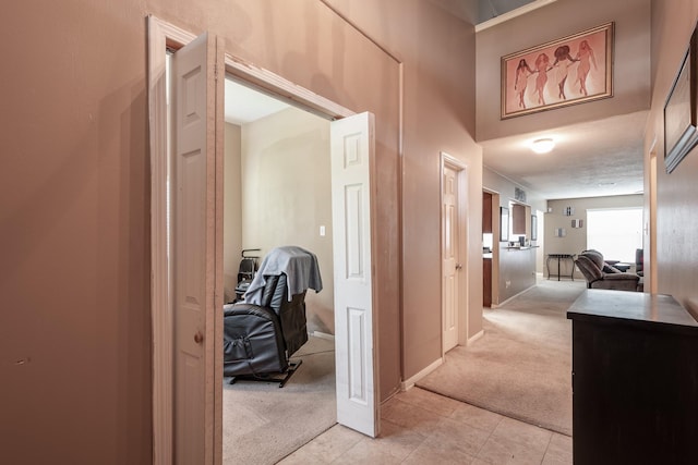 934 Sage St, Baytown, TX 77521 - hallway featuring light colored carpet, light tile patterned floors, and baseboards