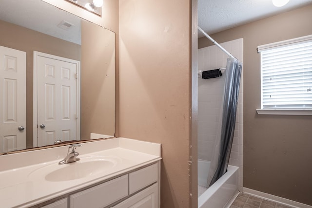 934 Sage St, Baytown, TX 77521 - bathroom featuring vanity, shower / tub combo with curtain, a textured ceiling, and baseboards