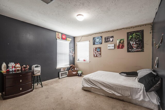 934 Sage St, Baytown, TX 77521 - bedroom featuring carpet flooring, a textured ceiling, and baseboards