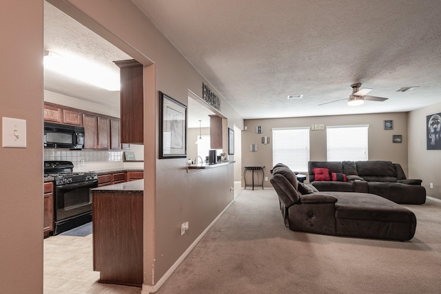 934 Sage St, Baytown, TX 77521 - living room featuring ceiling fan, baseboards, a textured ceiling, and light colored carpet