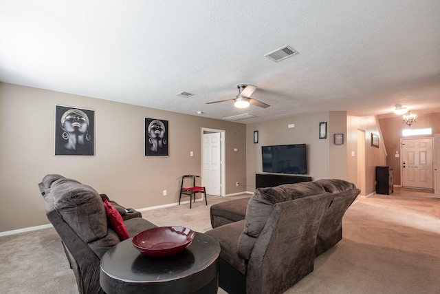 934 Sage St, Baytown, TX 77521 - living area featuring light carpet, baseboards, a ceiling fan, and a textured ceiling