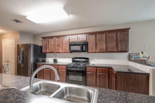 934 Sage St, Baytown, TX 77521 - kitchen with black appliances, a sink, decorative backsplash, and a textured ceiling
