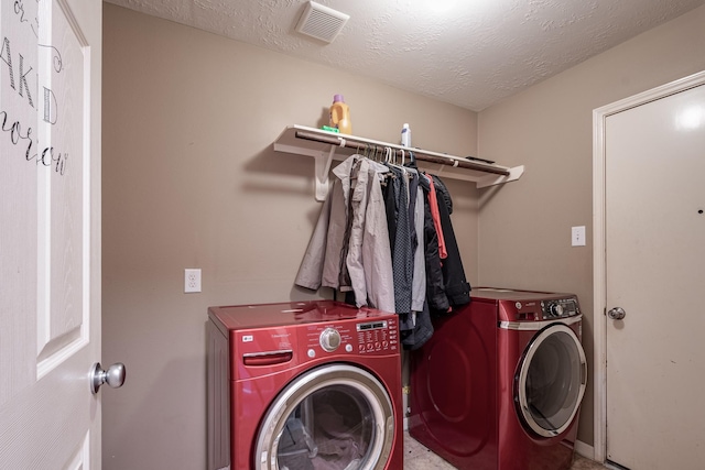 934 Sage St, Baytown, TX 77521 - washroom featuring washer and clothes dryer and a textured ceiling