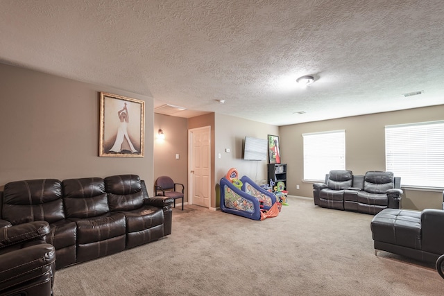 934 Sage St, Baytown, TX 77521 - carpeted living room featuring a textured ceiling