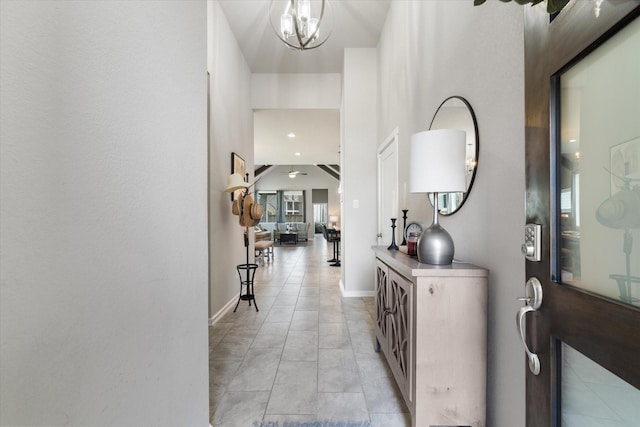 6903 Aspen Peak Dr, Baytown, TX 77521 - corridor featuring a chandelier, light tile patterned floors, and baseboards