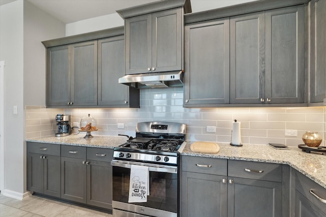 6903 Aspen Peak Dr, Baytown, TX 77521 - kitchen with gas stove, under cabinet range hood, and gray cabinets