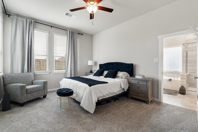 6903 Aspen Peak Dr, Baytown, TX 77521 - carpeted bedroom featuring multiple windows, baseboards, a ceiling fan, and ensuite bathroom