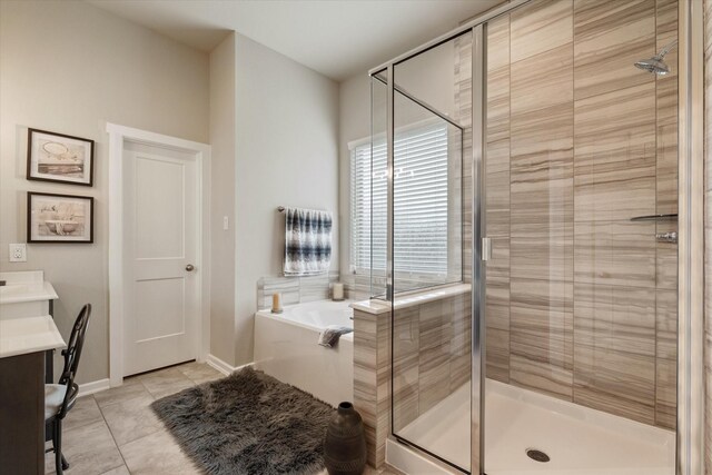 6903 Aspen Peak Dr, Baytown, TX 77521 - full bathroom featuring a garden tub, vanity, a shower stall, tile patterned floors, and baseboards